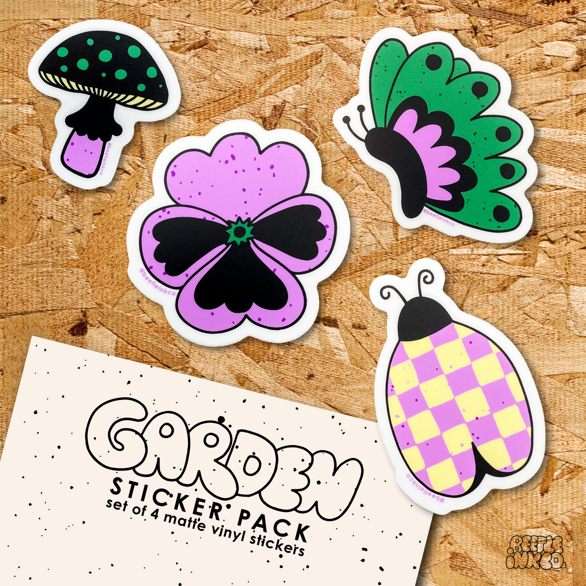 A garden sticker pack spills out onto a wood particle board.